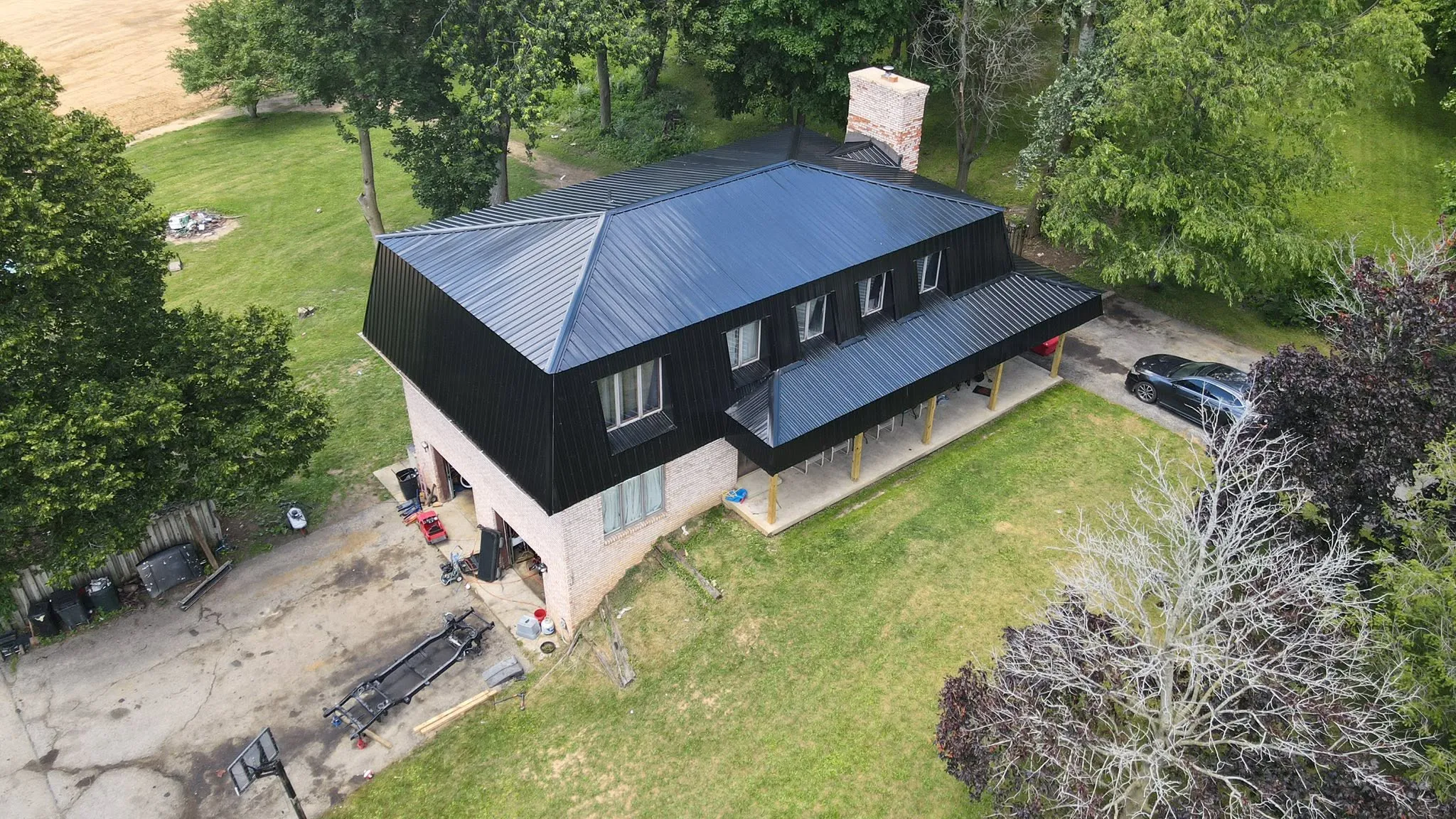 New black standing-seam metal roof on a two-story home
