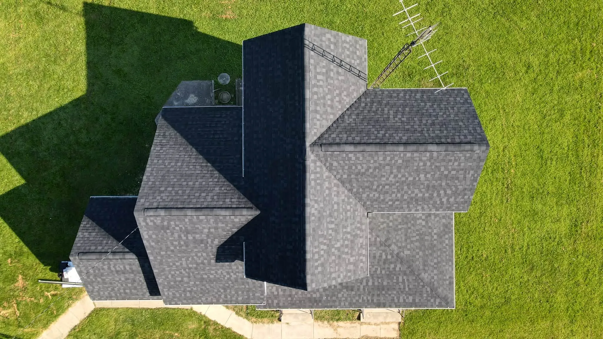 Top-down view of a new black shingle roof on a farmhouse