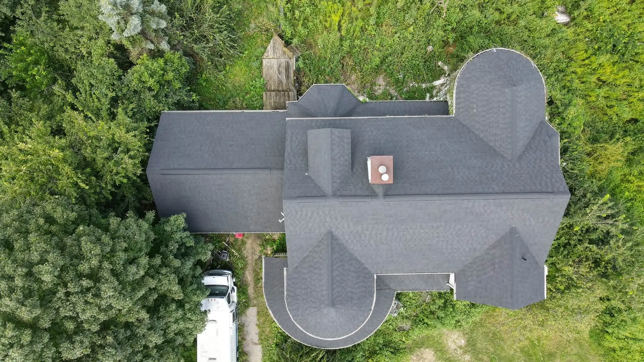 New gray shingle roof on a Victorian home with turret